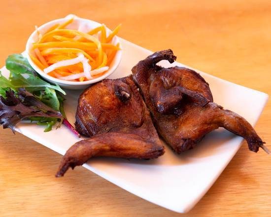 Two crispy fried butter quail with pickled vegetables and salad
